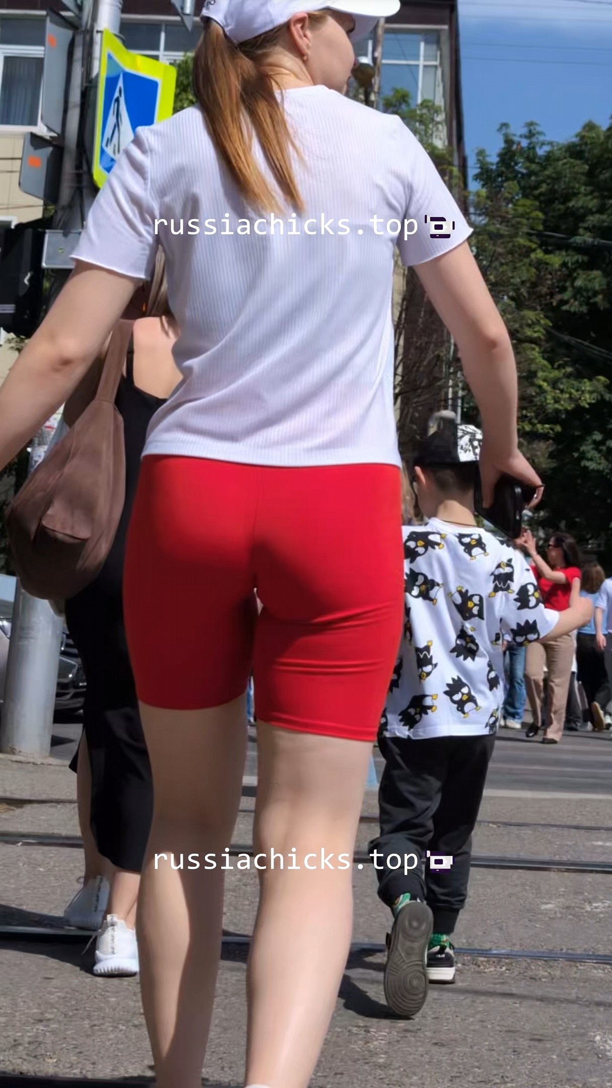 2 chicks on street and their butts