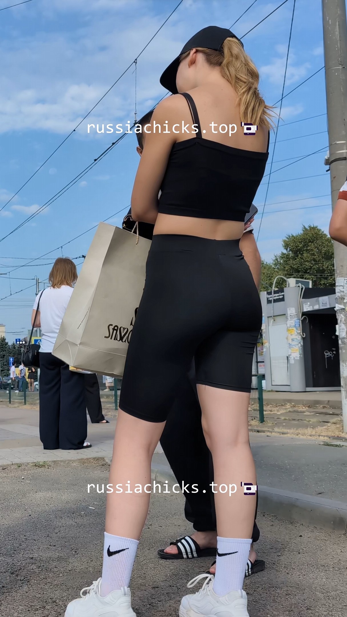 nice girl in tight short on tram stop