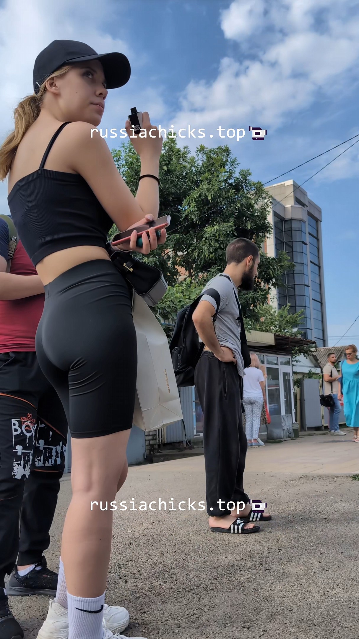 nice girl in tight short on tram stop