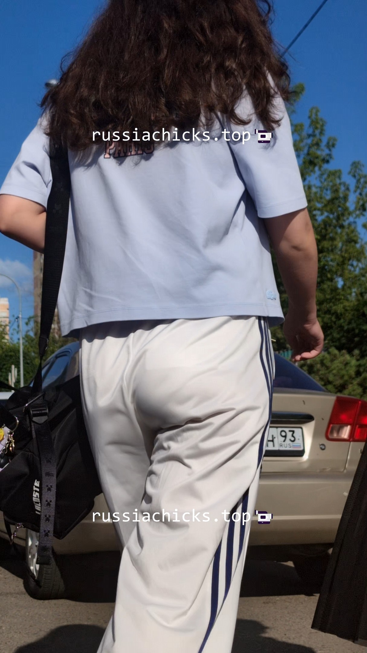 nice teen girl in white pants on street